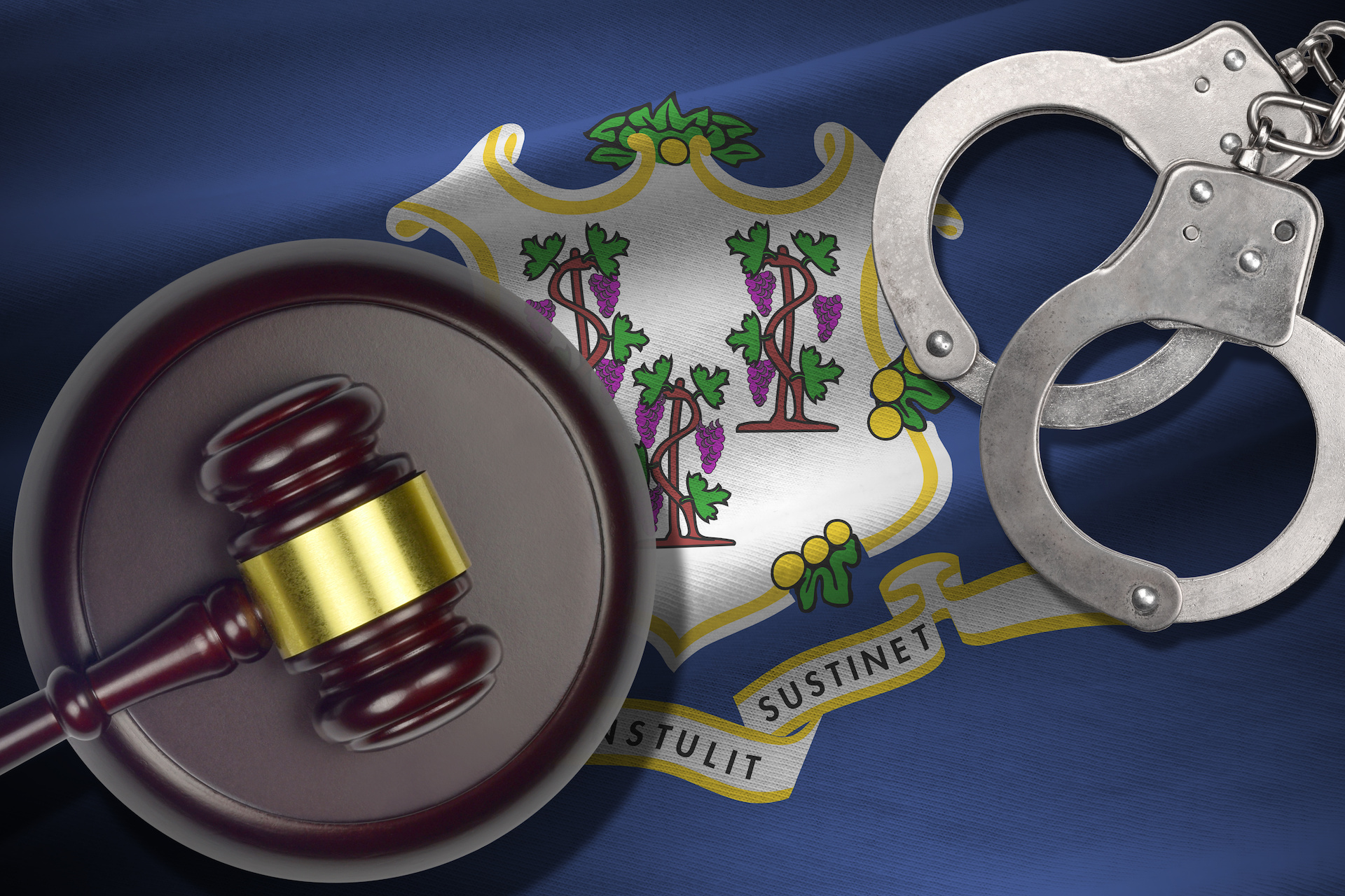 Connecticut US state flag with judge mallet and handcuffs in dark room. Concept of criminal and punishment, background for guilty topics